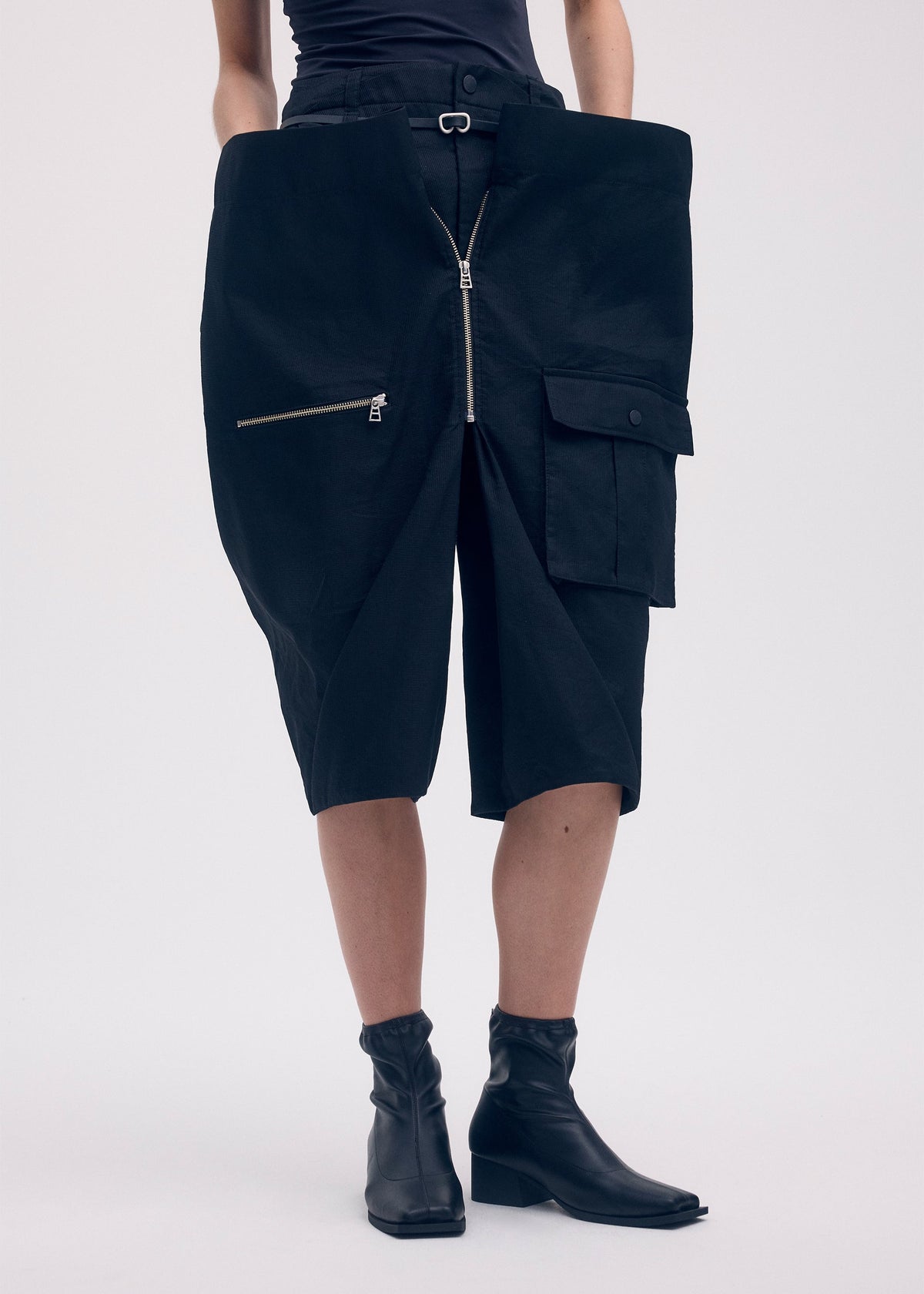 A model wears the Issey Miyake PEEKABOO trousers.