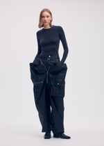 A model wears the Issey Miyake AERIAL STEEL trousers.