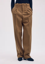 A model wears the Issey Miyake WOOL TWEED PANTS trousers.
