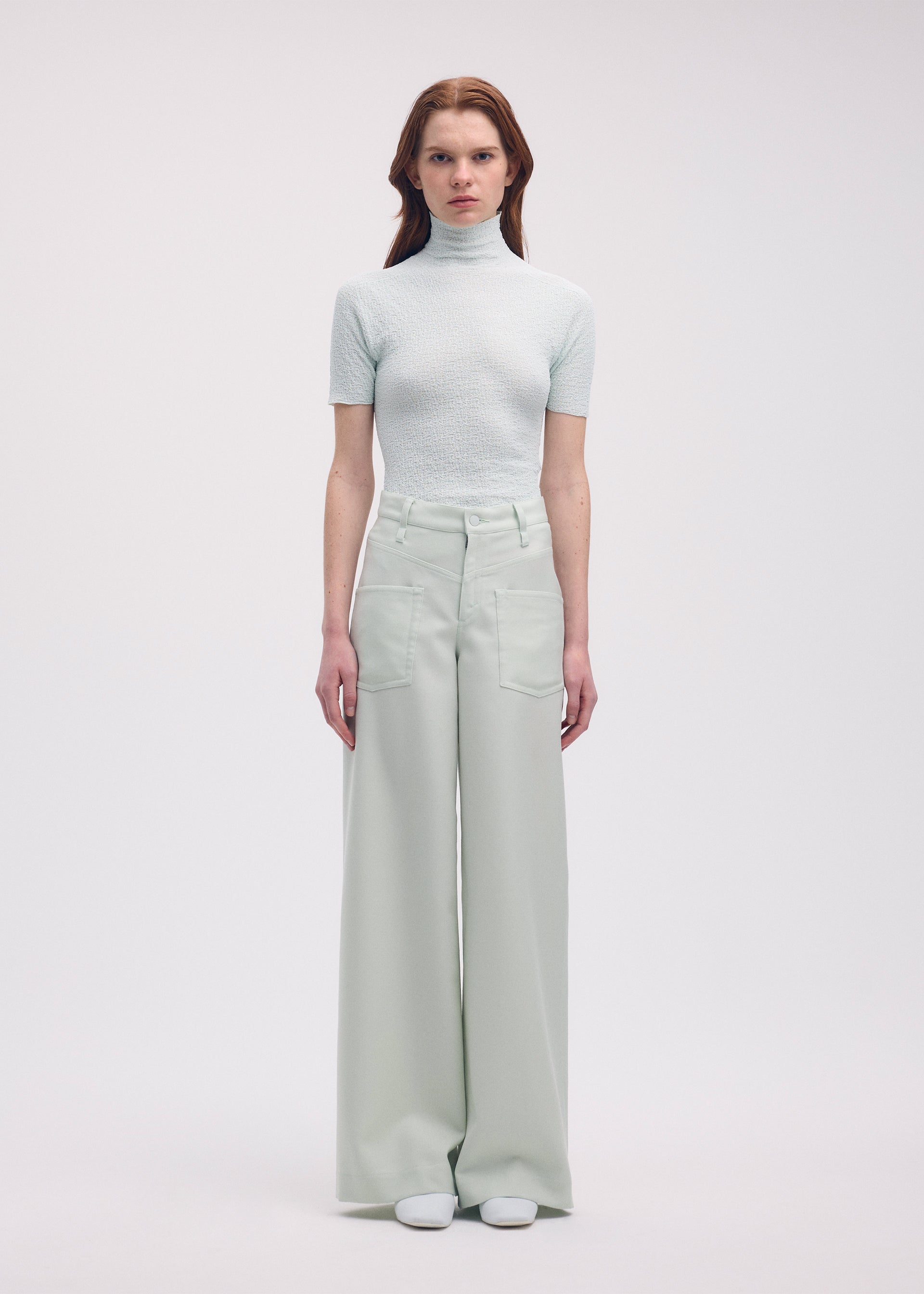 A model wears the Issey Miyake DISPOCKET Pants trousers.