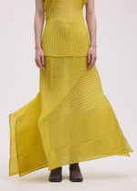 A model wears the Issey Miyake GENERIC STRIPES skirt.