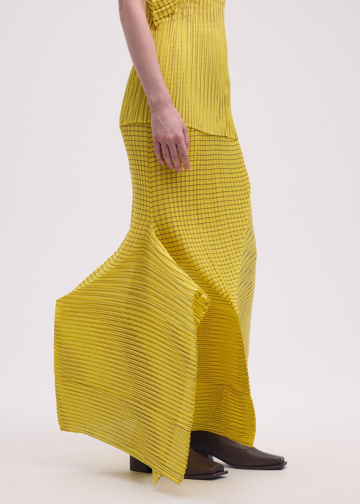 A model wears the Issey Miyake GENERIC STRIPES skirt.