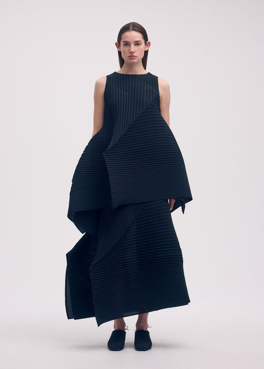 A model wears the ISSEY MIYAKE FOLD PLEATS skirt.