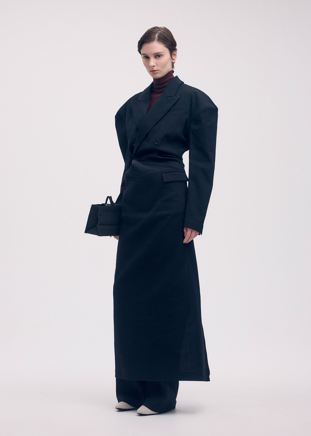 A model wears the Issey Miyake LIKE TORSO LIKE BLAZER dress.