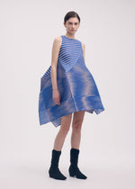 A model wears the Issey Miyake GENERIC STRIPES dress.