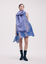 A model wears the Issey Miyake GENERIC STRIPES dress.