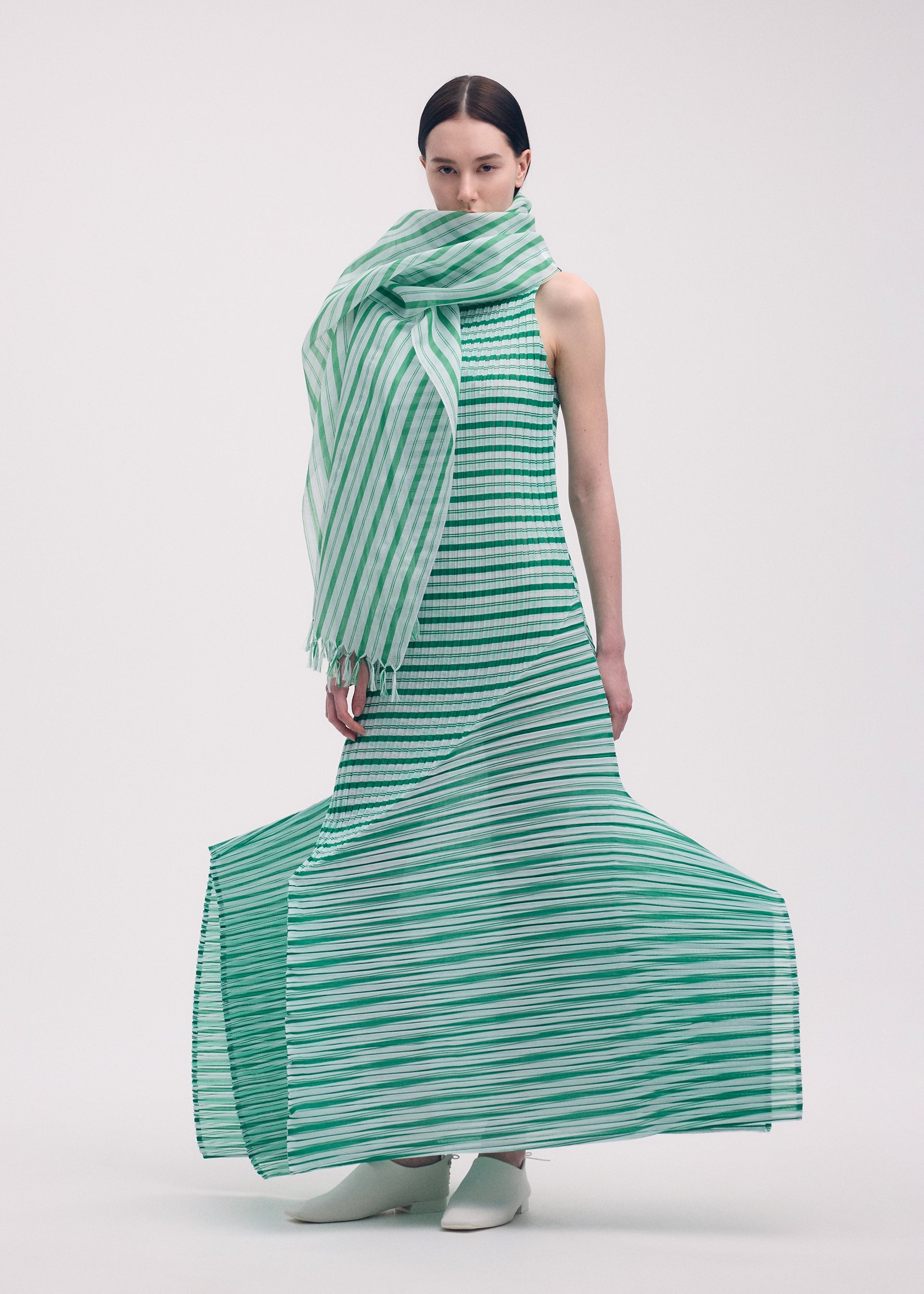A model wears the Issey Miyake GENERIC STRIPES dress.