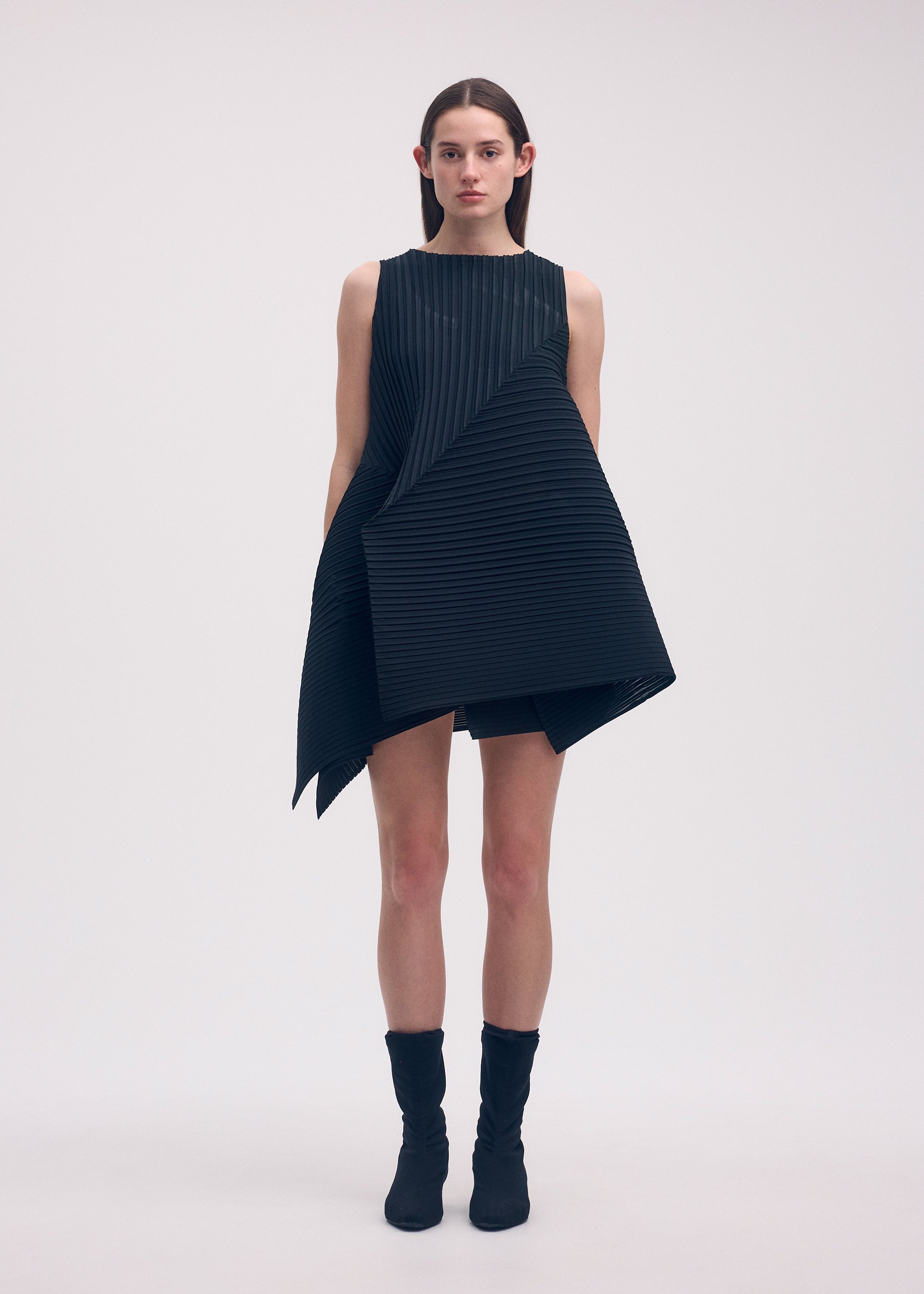 A model wears the ISSEY MIYAKE FOLD PLEATS dress.
