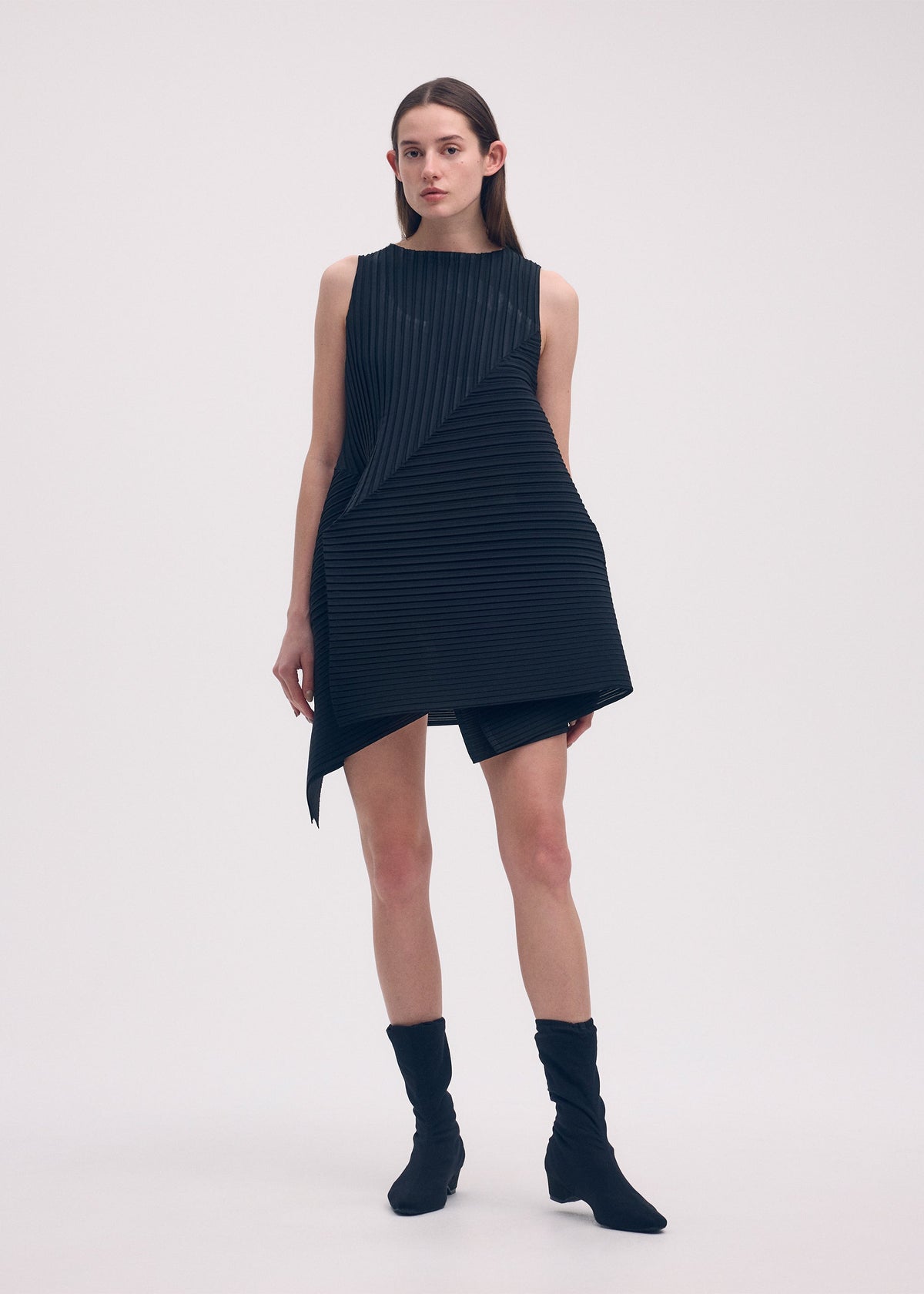 A model wears the ISSEY MIYAKE FOLD PLEATS dress.