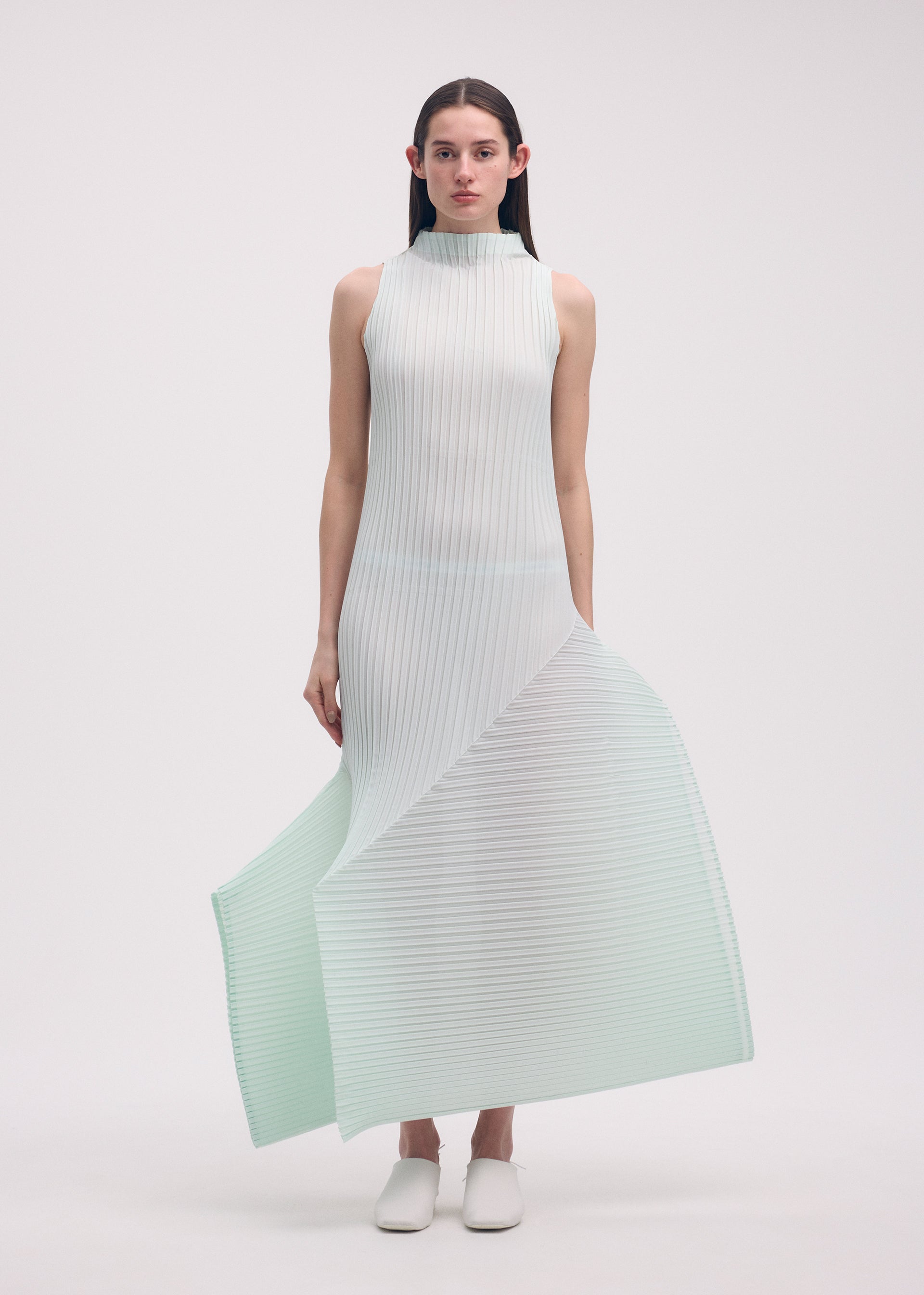 A model wears the ISSEY MIYAKE FOLD PLEATS dress.