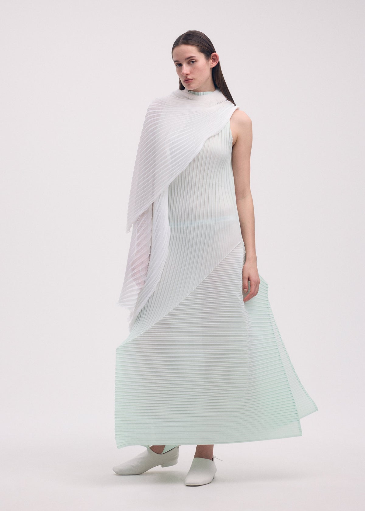 A model wears the ISSEY MIYAKE FOLD PLEATS dress.