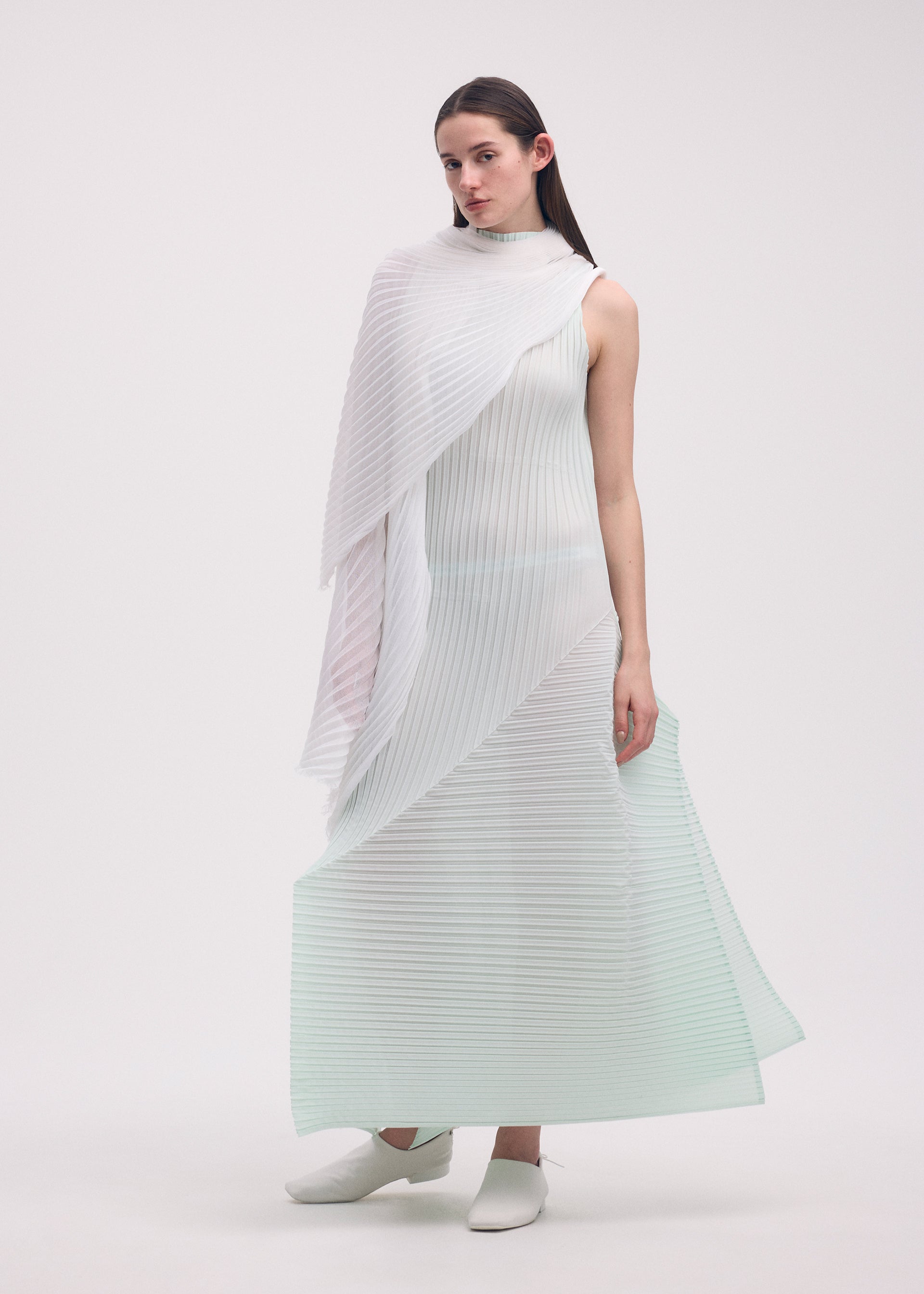 A model wears the ISSEY MIYAKE FOLD PLEATS dress.