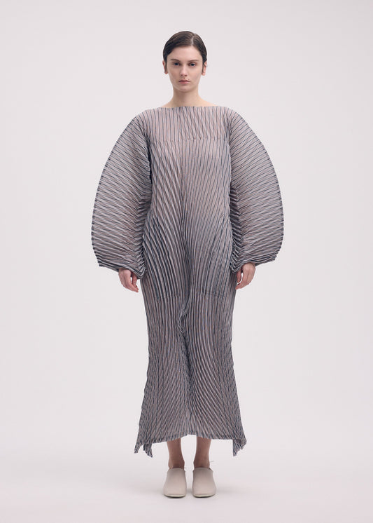 A model wears the Issey Miyake GENERIC STRIPES HAND PLEATS dress.