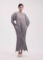 A model wears the Issey Miyake GENERIC STRIPES HAND PLEATS dress.