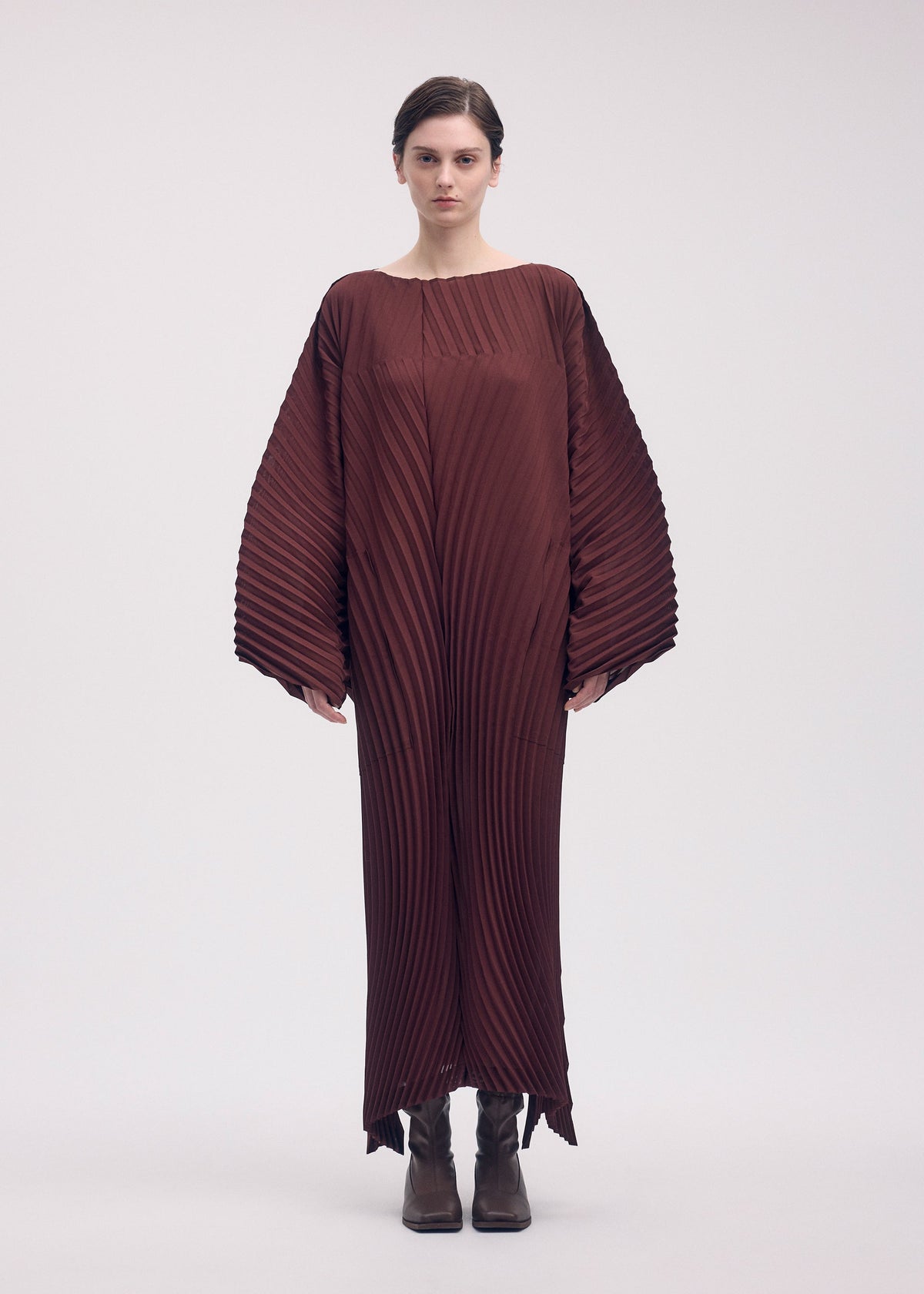 A model wears the ISSEY MIYAKE WAVE PLEATS dress.