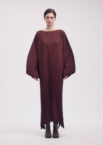A model wears the ISSEY MIYAKE WAVE PLEATS dress.