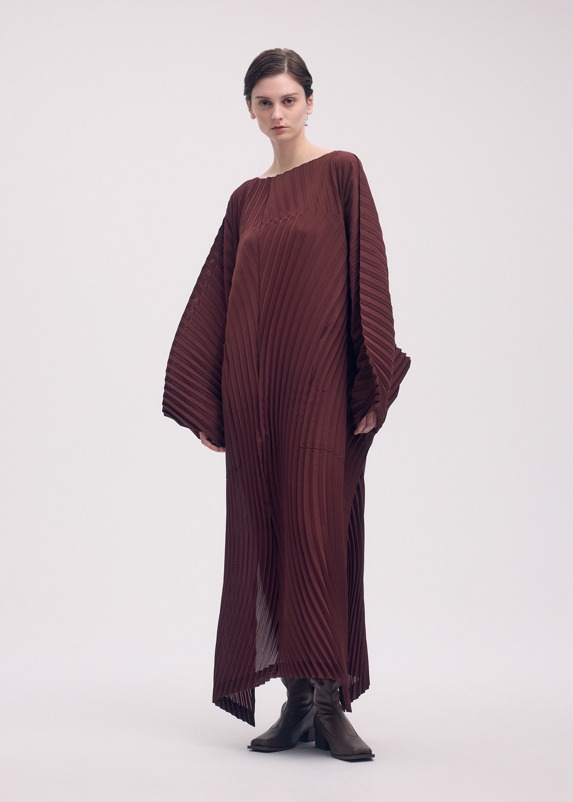 A model wears the ISSEY MIYAKE WAVE PLEATS dress.