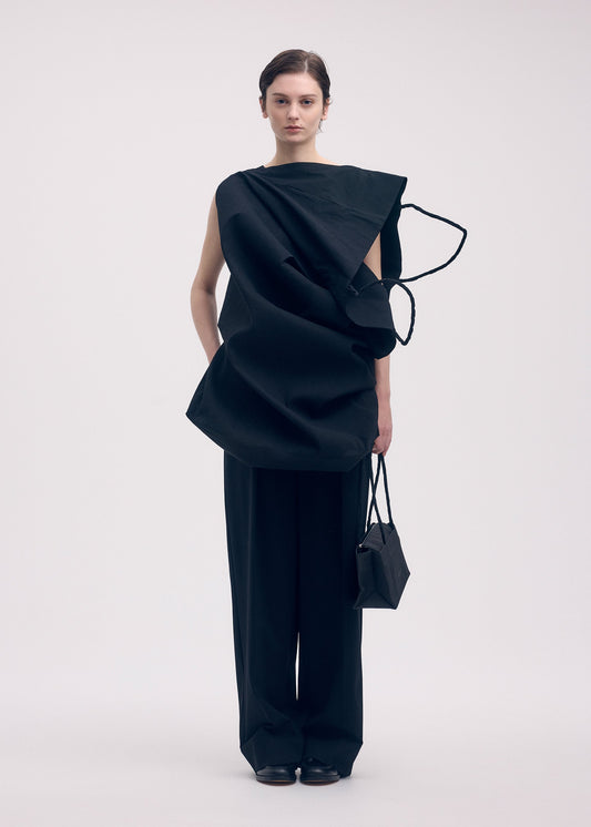 A model wears the ISSEY MIYAKE PAPER BAG shirt.