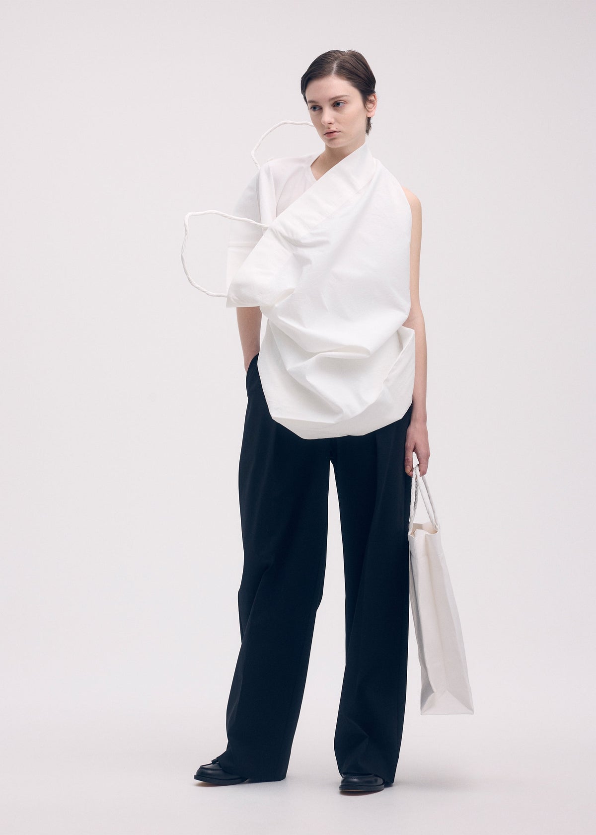 A model wears the ISSEY MIYAKE PAPER BAG shirt.