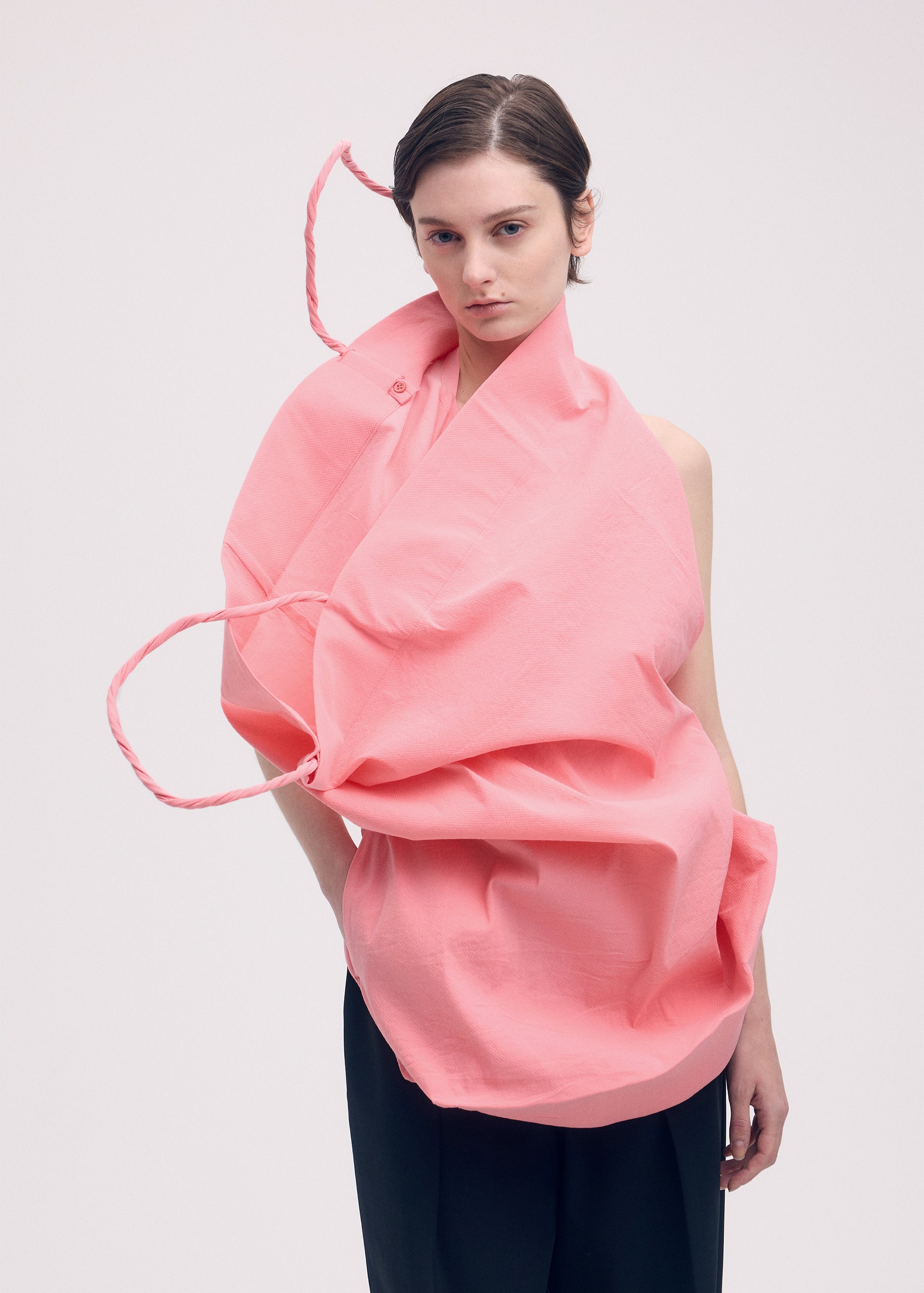 A model wears the ISSEY MIYAKE PAPER BAG shirt.