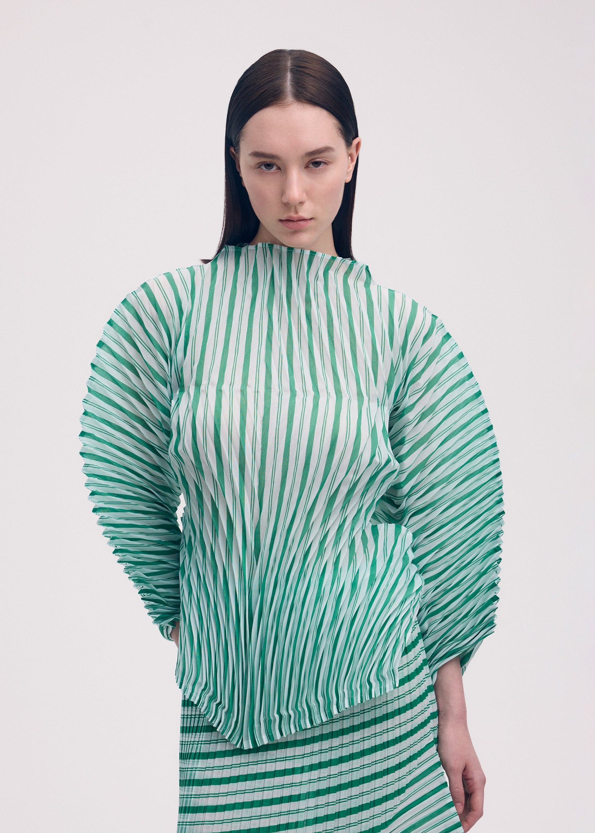 A model wears the Issey Miyake GENERIC STRIPES HAND PLEATS prêt à porter.