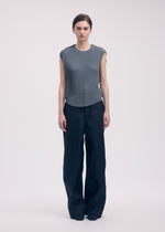 A model wears the Issey Miyake RESTORE BLEND PLEATS shirt.