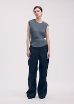 A model wears the Issey Miyake RESTORE BLEND PLEATS shirt.