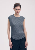 A model wears the Issey Miyake RESTORE BLEND PLEATS shirt.