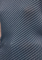 A model wears the Issey Miyake RESTORE BLEND PLEATS shirt.