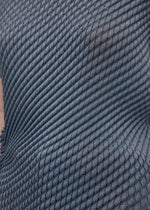 A model wears the Issey Miyake RESTORE BLEND PLEATS shirt.