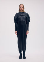 A model wears the Issey Miyake GLOSSED METAL PLEATS cardigan.
