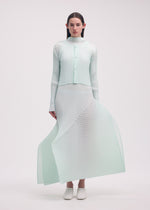 A model wears the ISSEY MIYAKE FOLD PLEATS cardigan.