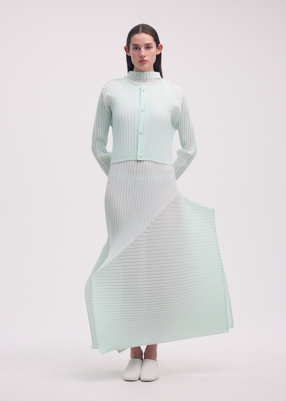 A model wears the ISSEY MIYAKE FOLD PLEATS cardigan.