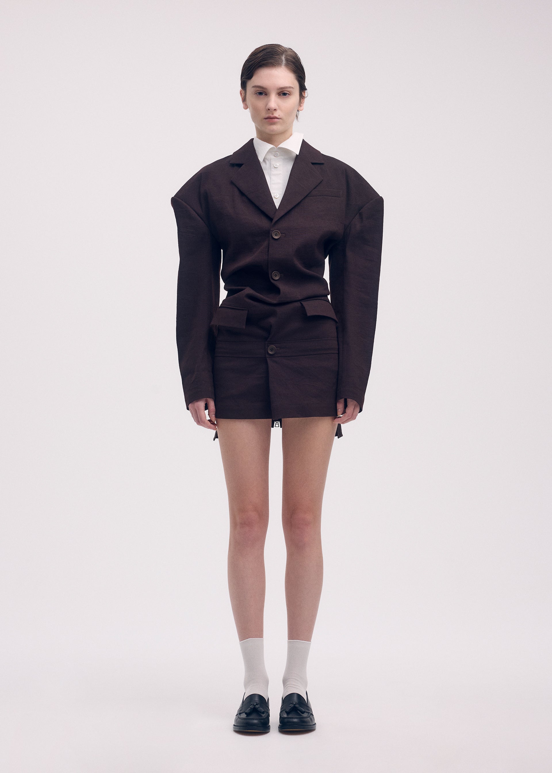 A model wears the Issey Miyake LIKE TORSO LIKE BLAZER dress.