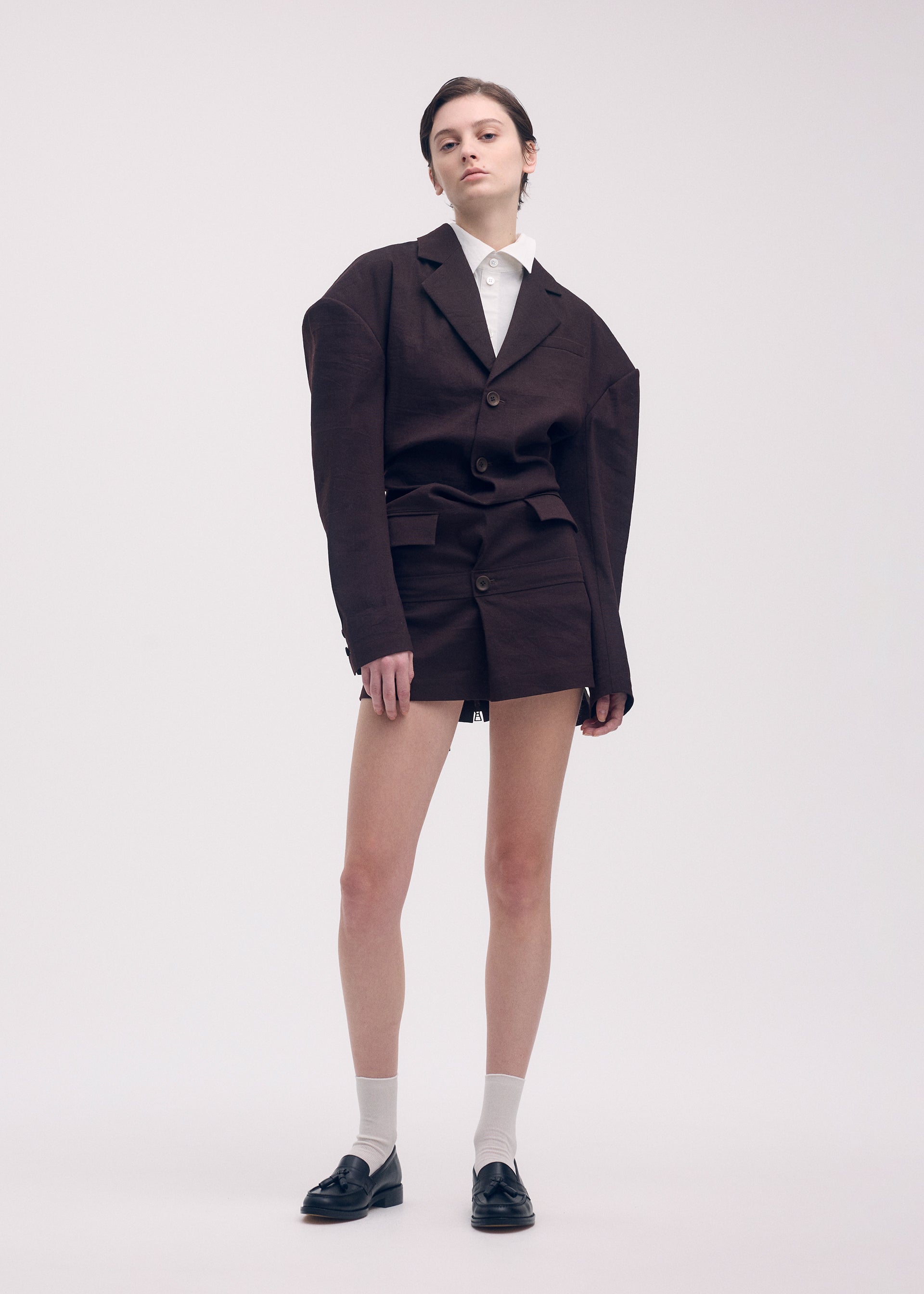 A model wears the Issey Miyake LIKE TORSO LIKE BLAZER dress.