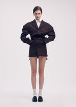 A model wears the Issey Miyake LIKE TORSO LIKE BLAZER dress.