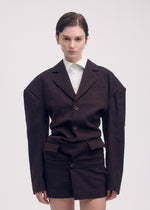 A model wears the Issey Miyake LIKE TORSO LIKE BLAZER dress.