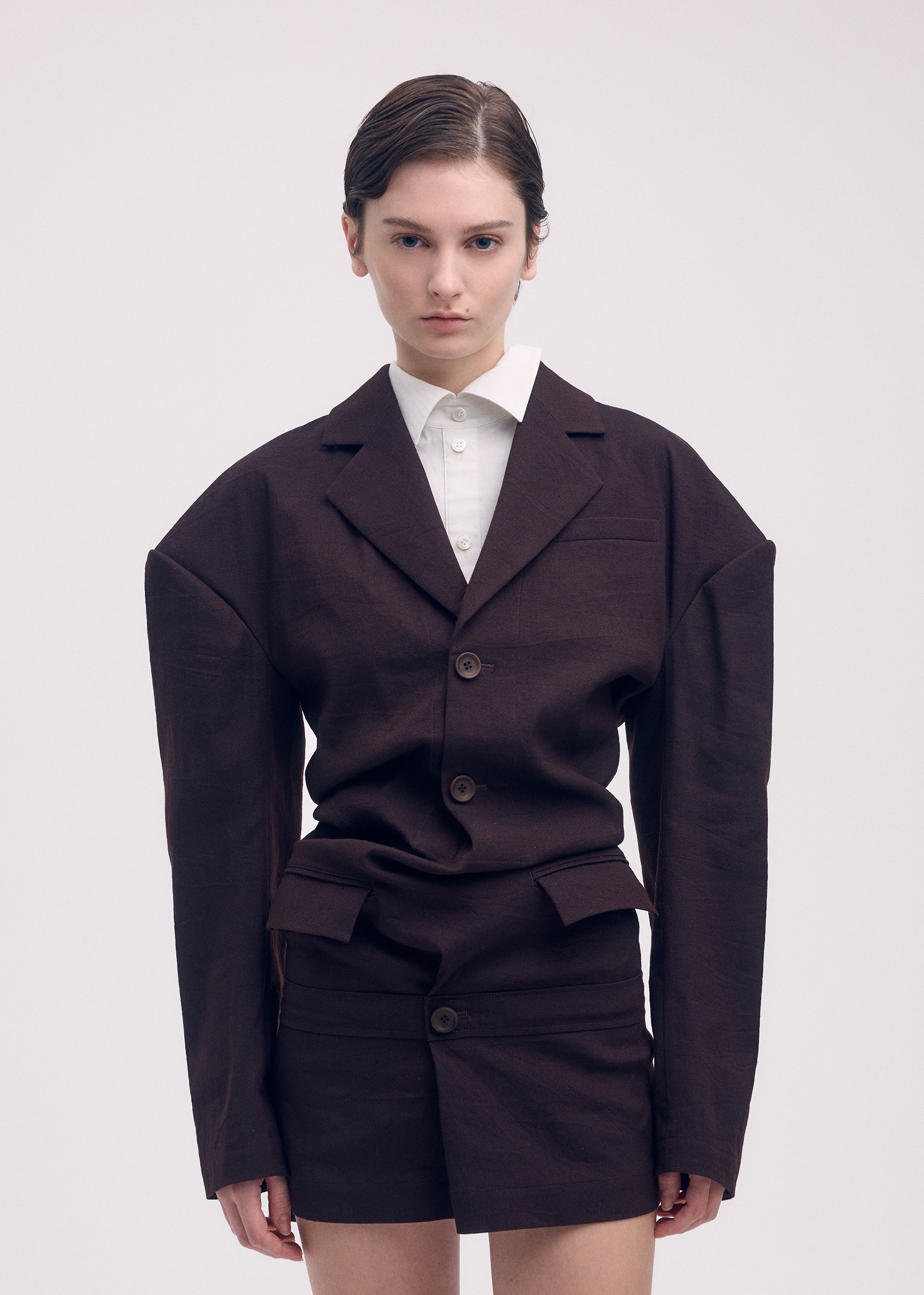 A model wears the Issey Miyake LIKE TORSO LIKE BLAZER dress.