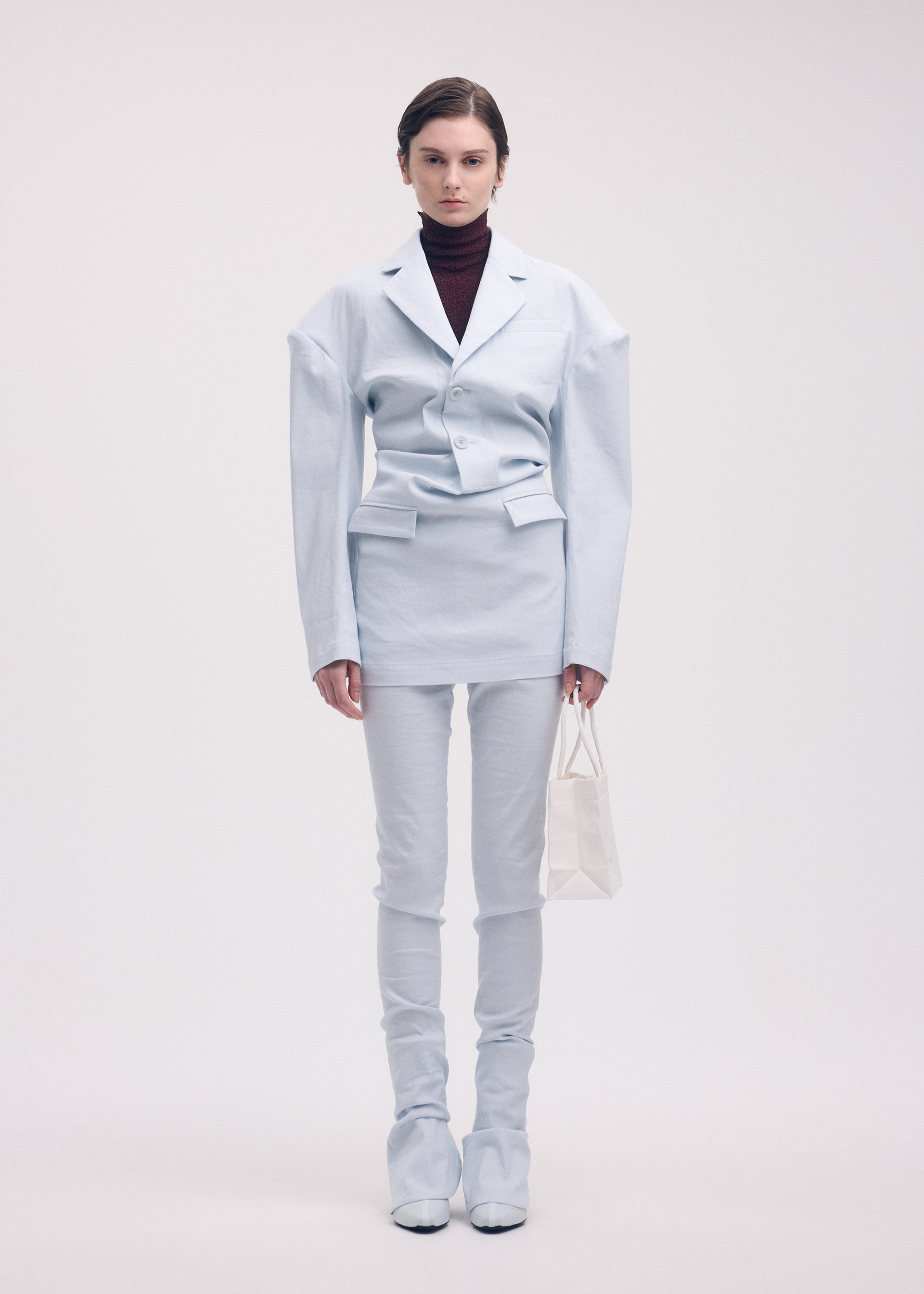 A model wears the Issey Miyake LIKE TORSO LIKE BLAZER dress.