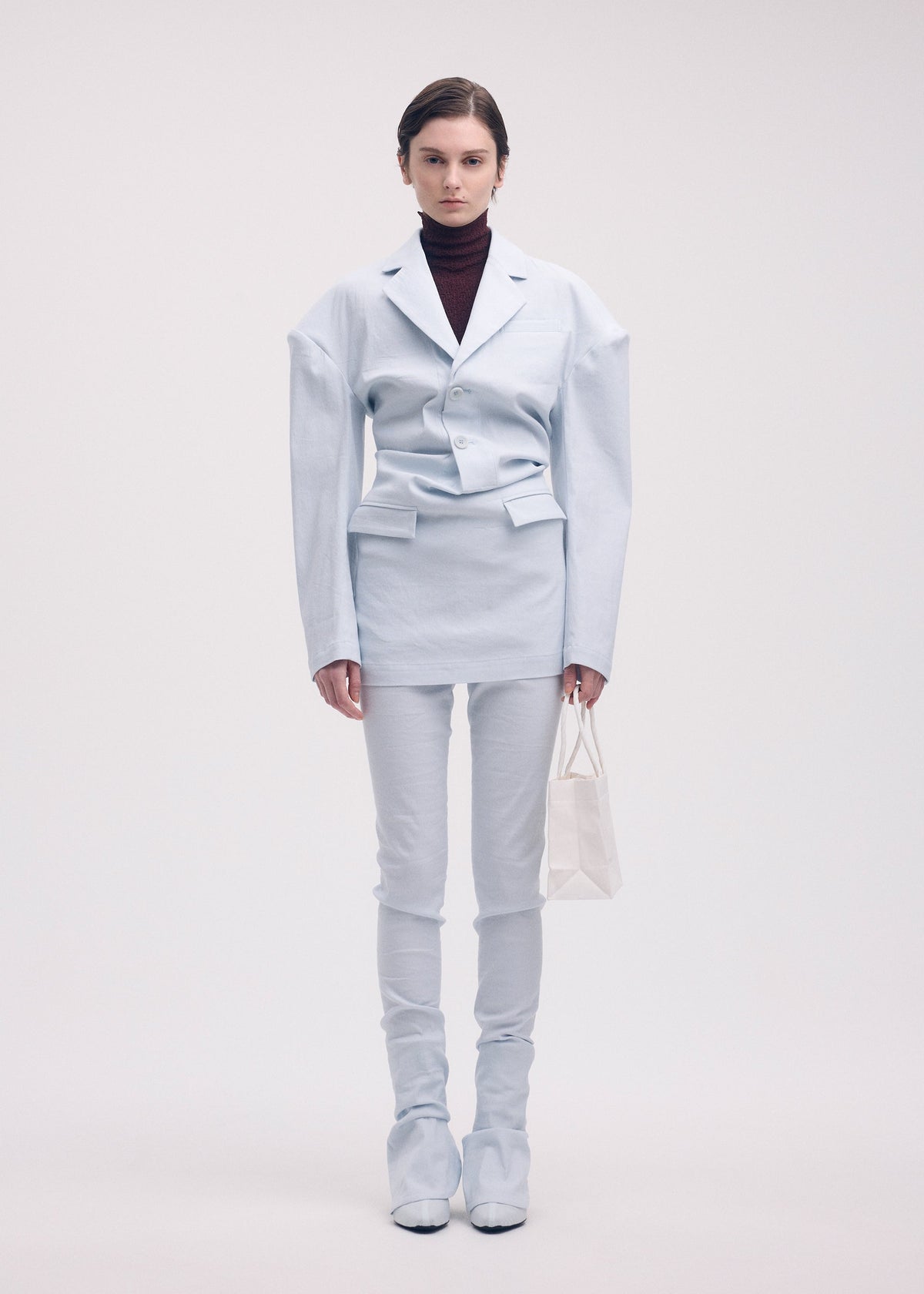 A model wears the Issey Miyake LIKE TORSO LIKE BLAZER dress.