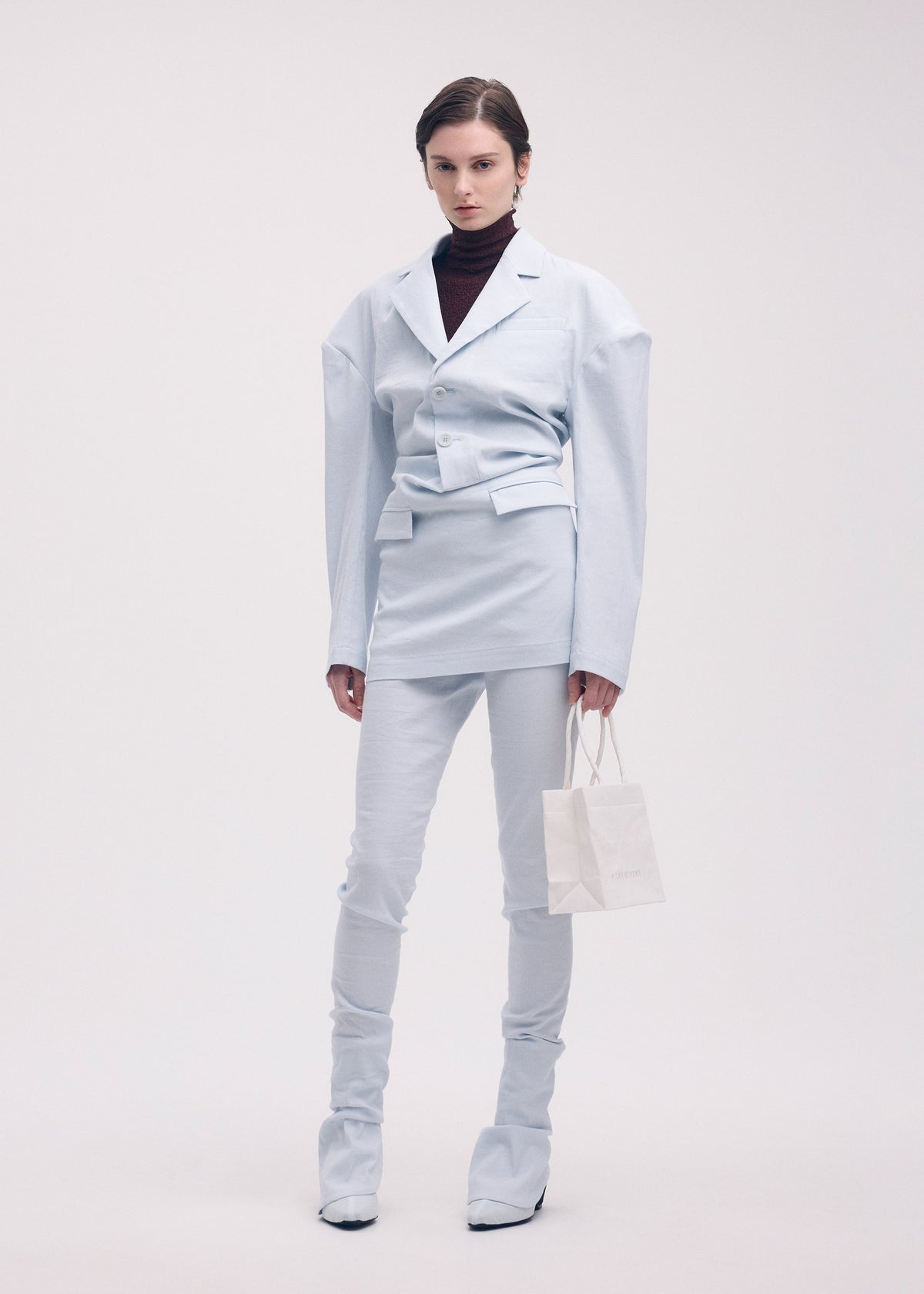 A model wears the Issey Miyake LIKE TORSO LIKE BLAZER dress.