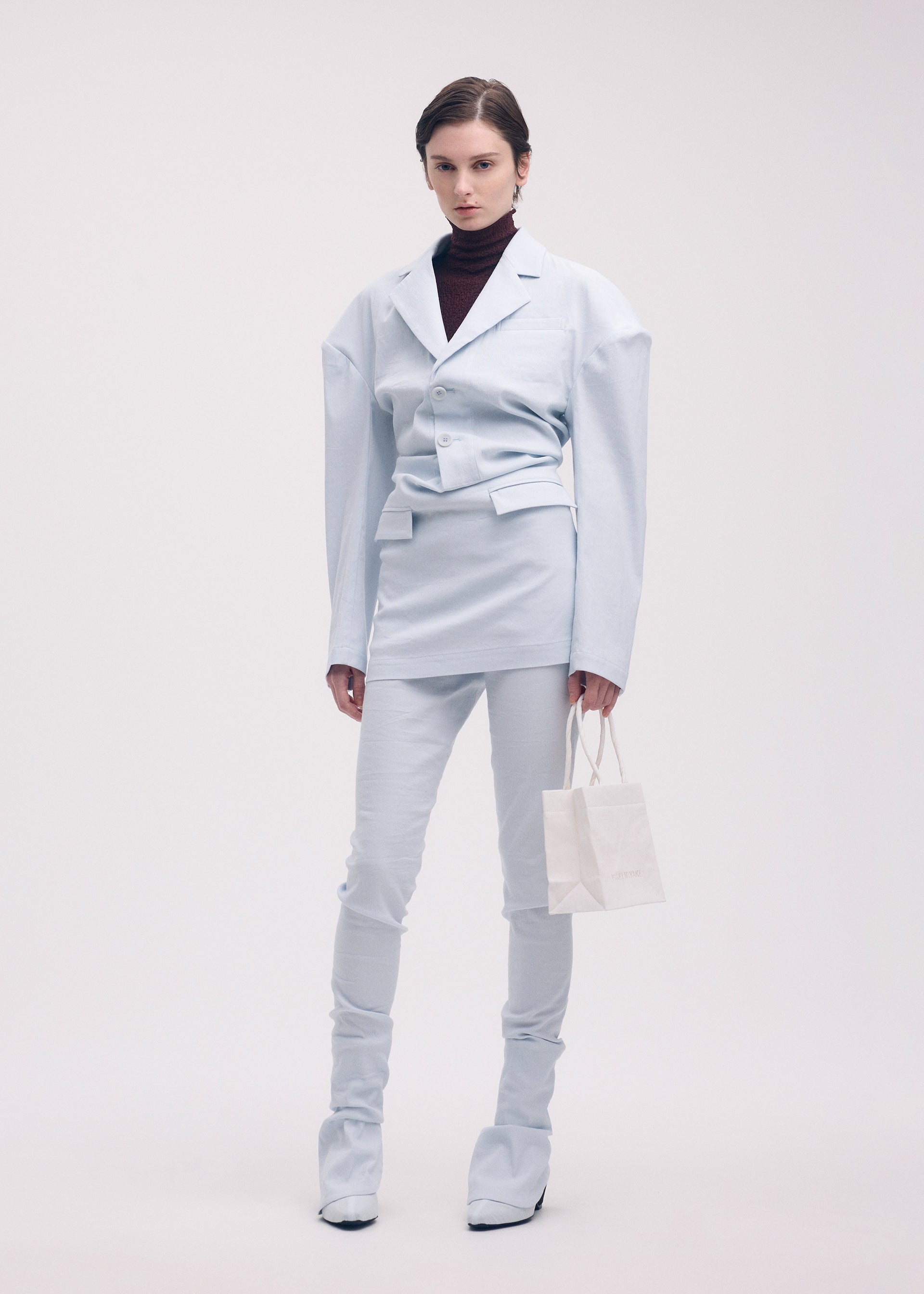 A model wears the Issey Miyake LIKE TORSO LIKE BLAZER dress.