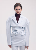 A model wears the Issey Miyake LIKE TORSO LIKE BLAZER dress.