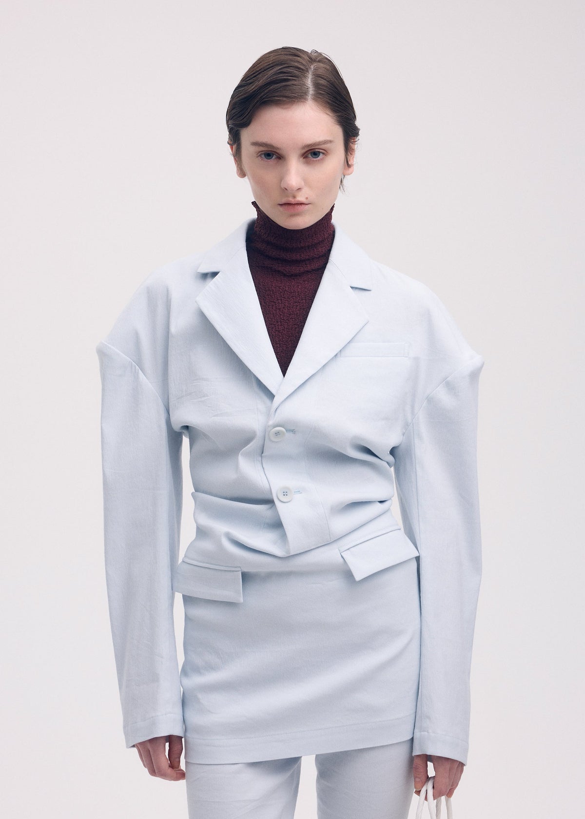 A model wears the Issey Miyake LIKE TORSO LIKE BLAZER dress.