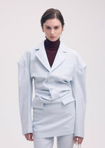 A model wears the Issey Miyake LIKE TORSO LIKE BLAZER dress.