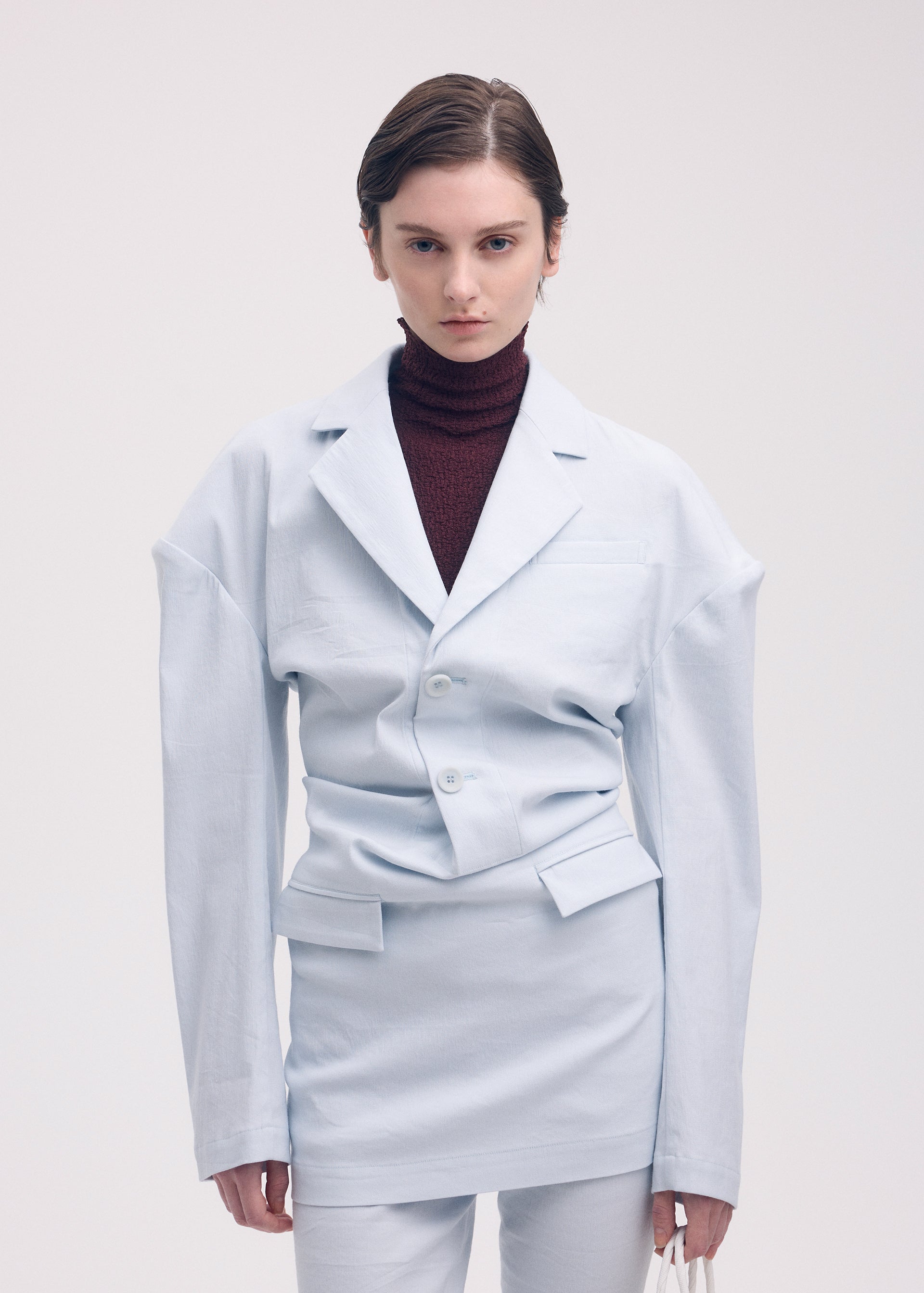 A model wears the Issey Miyake LIKE TORSO LIKE BLAZER dress.