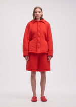 A model wears the ISSEY MIYAKE PUMPED T shirt.