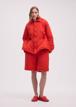 A model wears the ISSEY MIYAKE PUMPED T shirt.