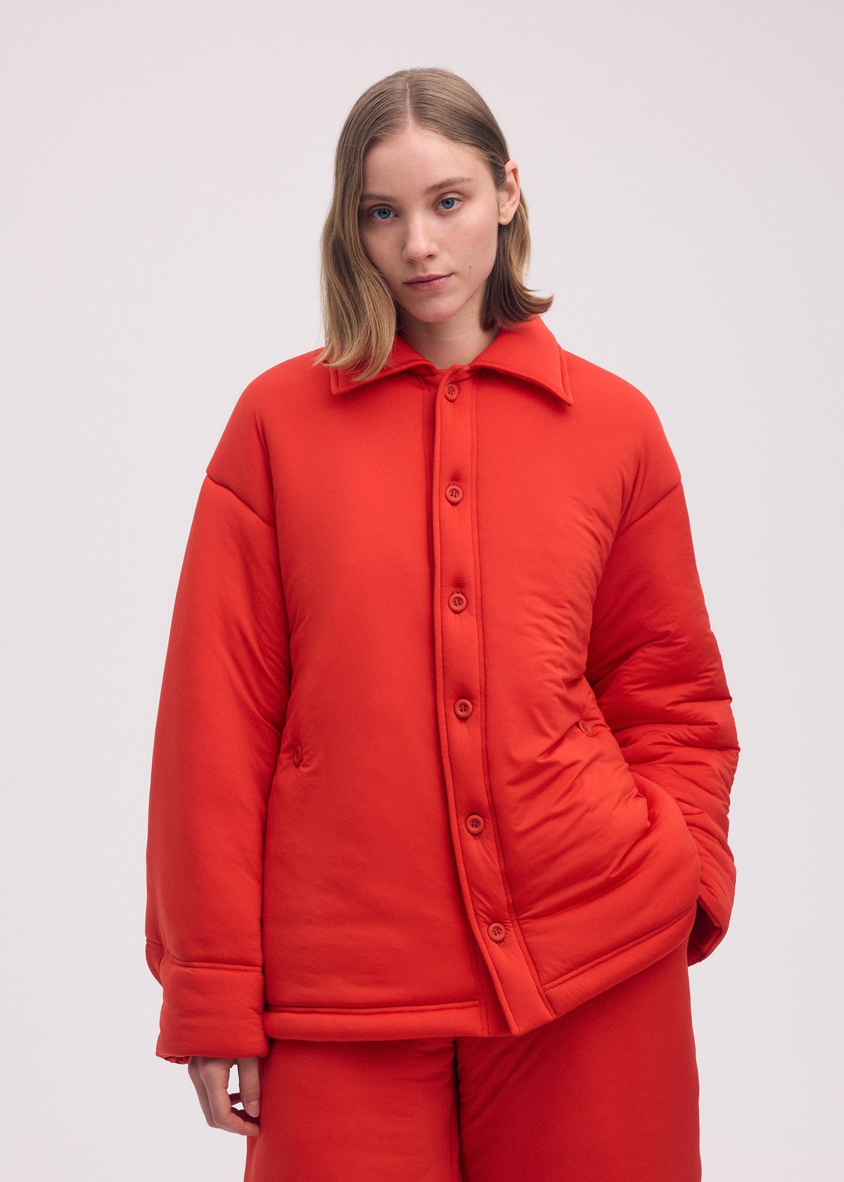 A model wears the ISSEY MIYAKE PUMPED T shirt.