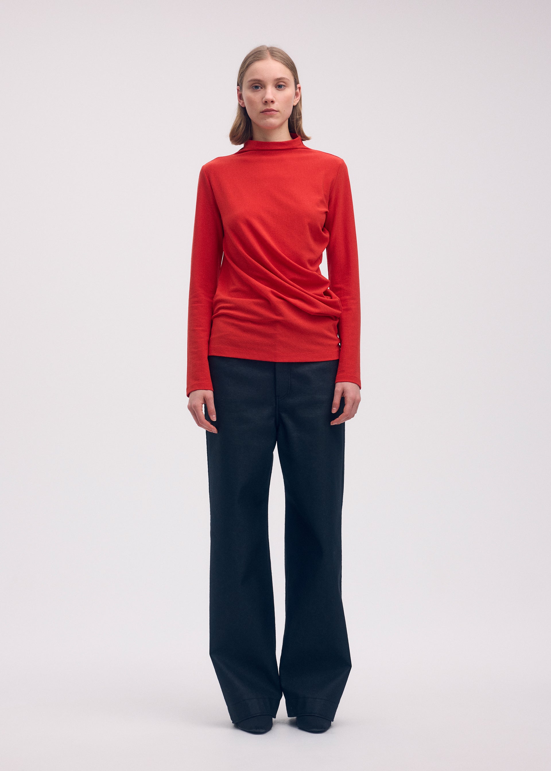 A model wears the Issey Miyake THREE SLEEVED JERSEY shirt.